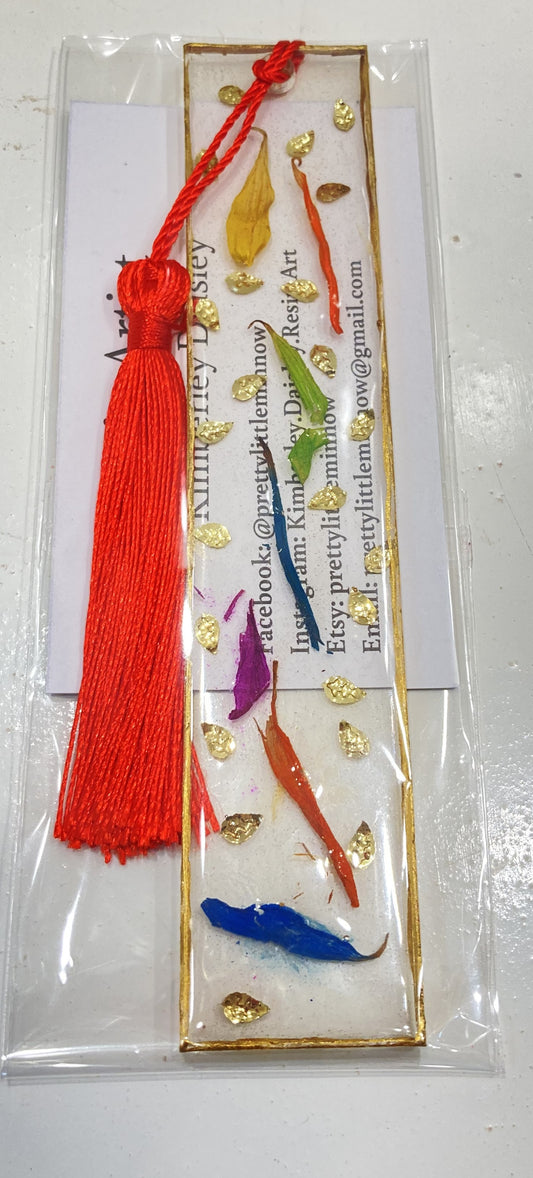 Clear bookmark with Yellow Orange Green Purple and Blue dried flowers & gold specs with gold trim and Orange tassel